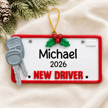 Personalized new driver license plate christmas ornament laid on a soft white knit blanket