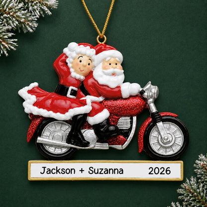 Personalized santa couple motorcycle christmas ornament on a dark green pine background