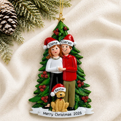Personalized couple with dog christmas ornament laid on a soft white knit blanket