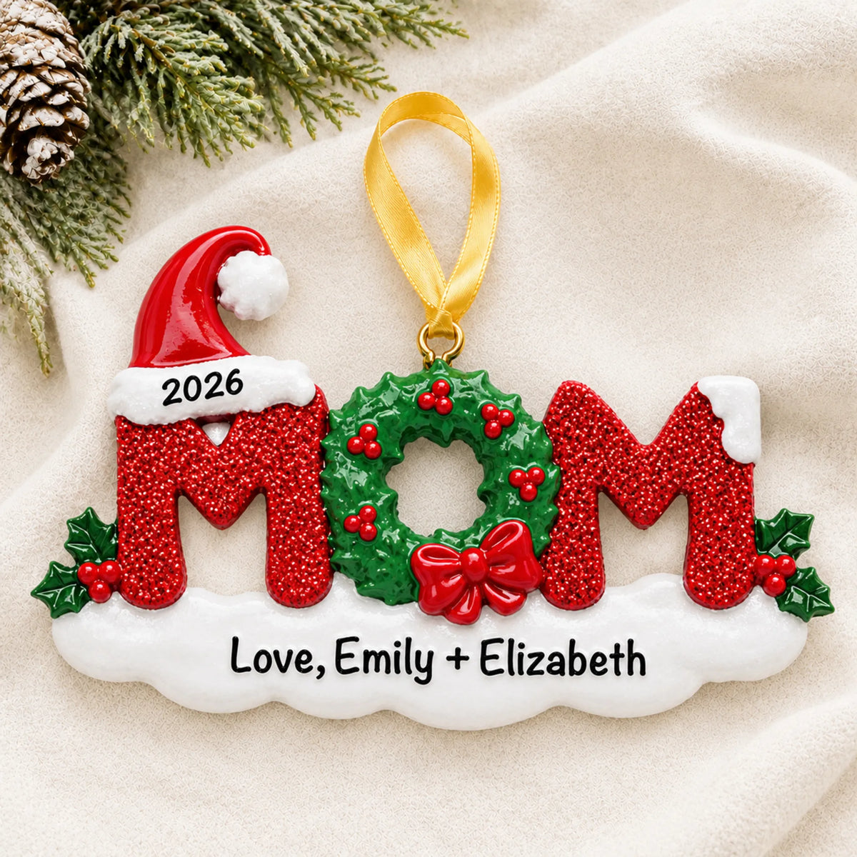 Personalized mom christmas ornament laid on a soft white knit blanket