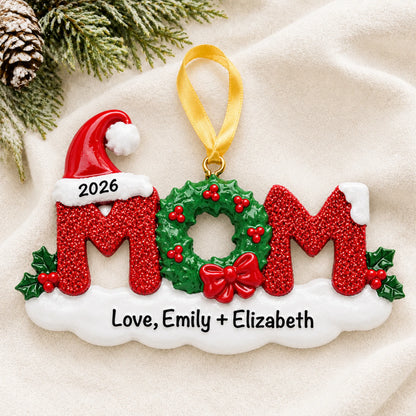 Personalized mom christmas ornament laid on a soft white knit blanket