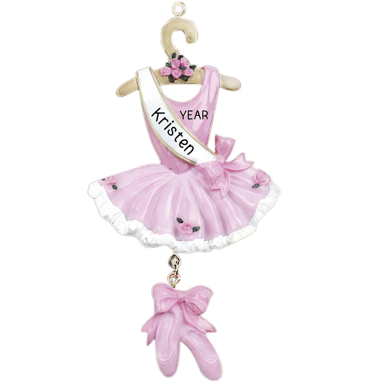 A personalized hanging ornament in the shape of a pink ballet dress with a white bow and a tag that reads 'Kristen' and 'Year'.