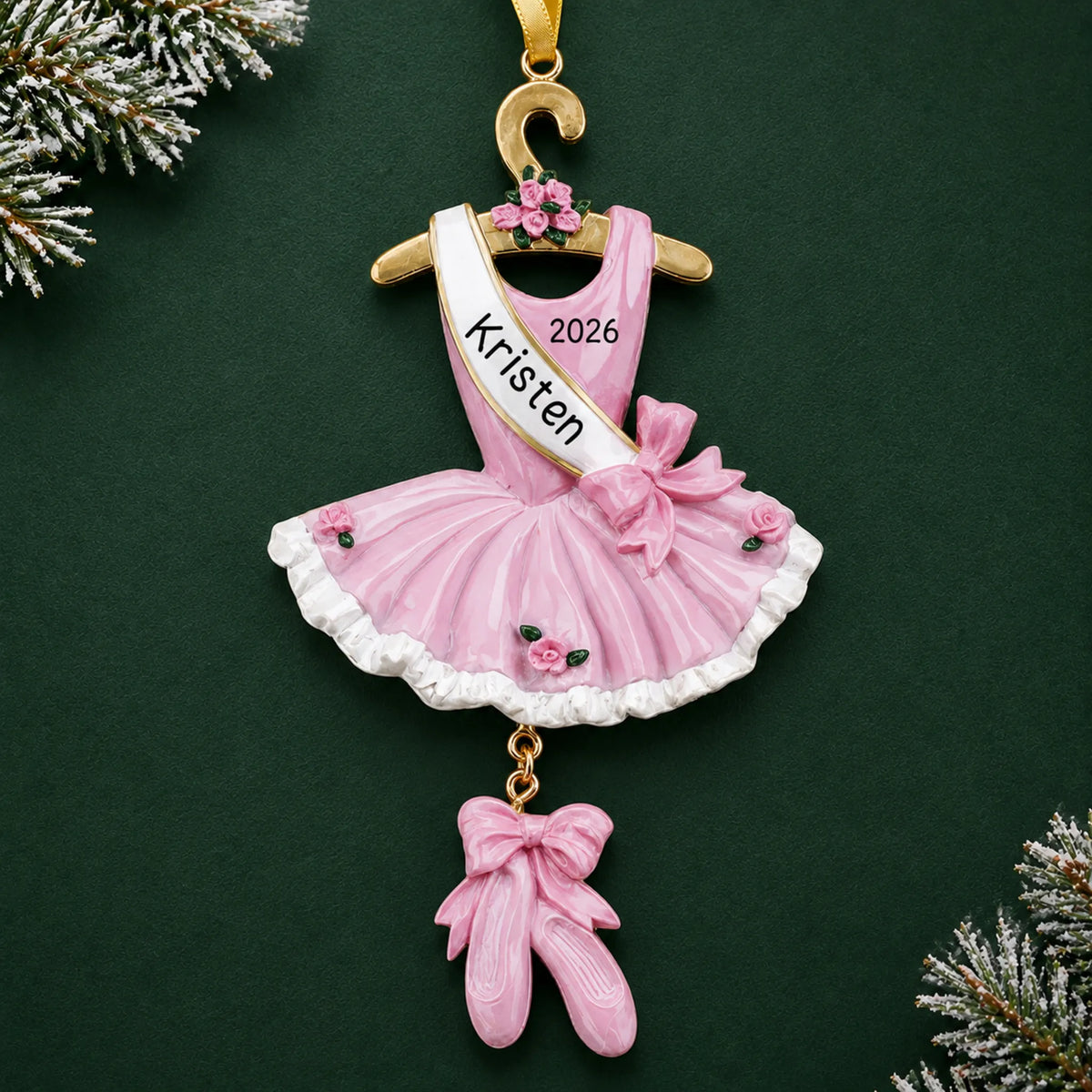 Personalized pink ballerina dress christmas ornament on a dark green pine background