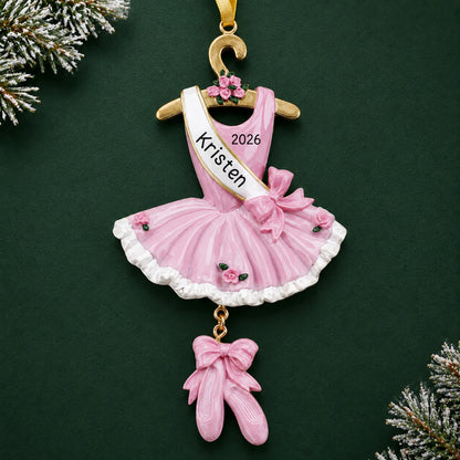 Personalized pink ballerina dress christmas ornament on a dark green pine background