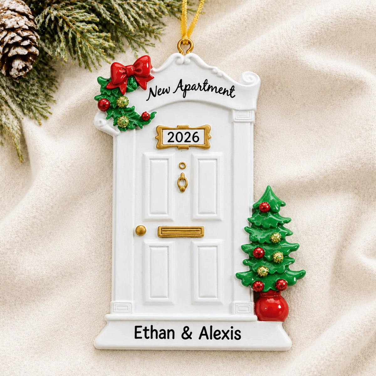 Personalized New Apartment christmas ornament laid on a soft white knit blanket