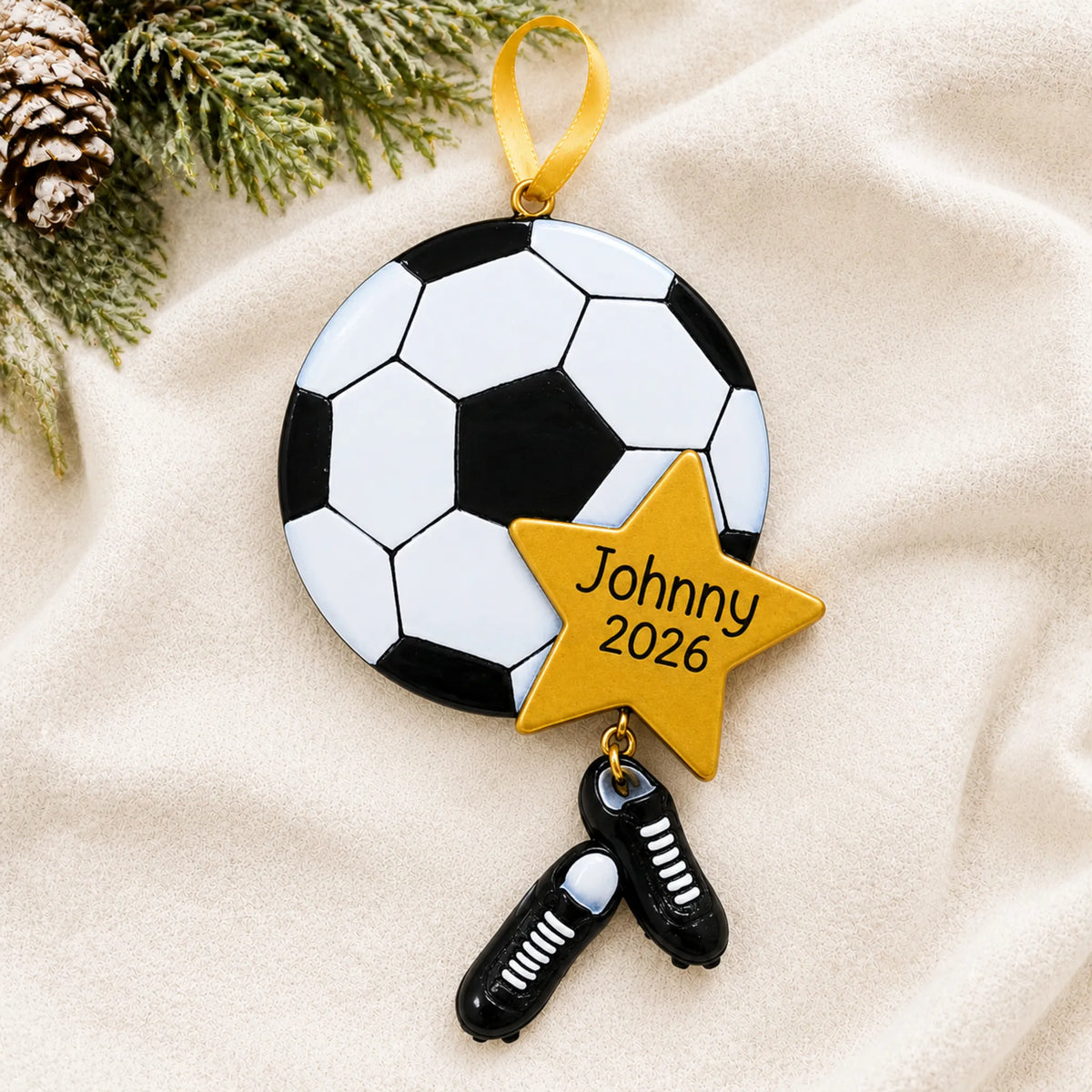 Personalized soccer star christmas ornament laid on a soft white knit blanket