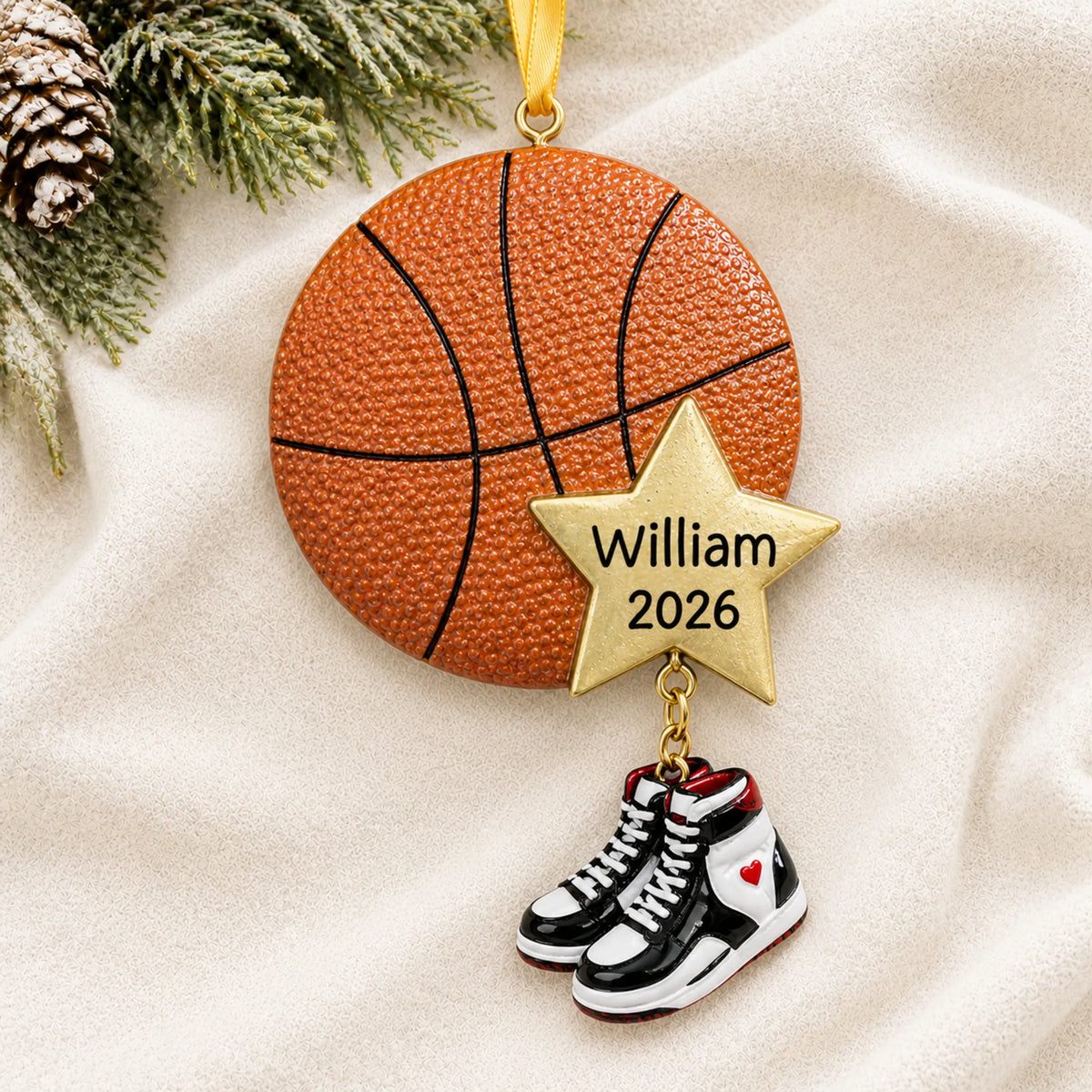 Personalized basketball star christmas ornament laid on a soft white knit blanket