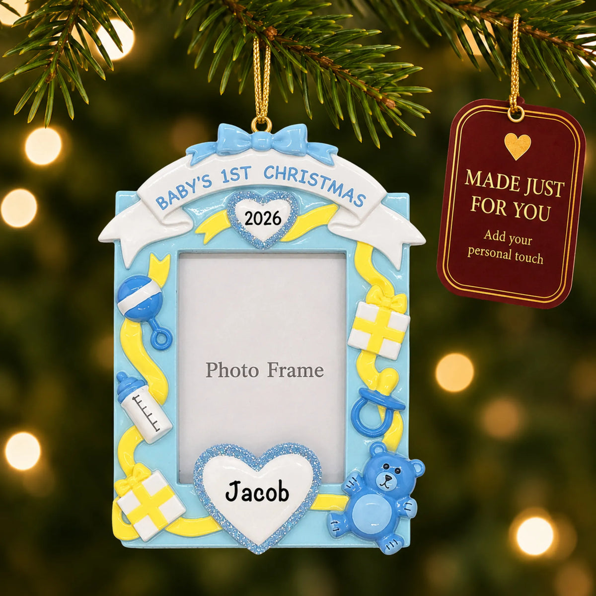Blue baby's 1st christmas photo frame ornament hanging on a lit Christmas tree with a Made Just For You gift tag