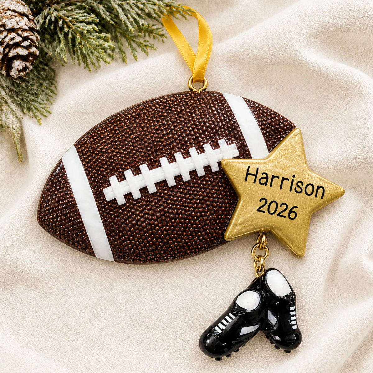 Personalized football star christmas ornament laid on a soft white knit blanket