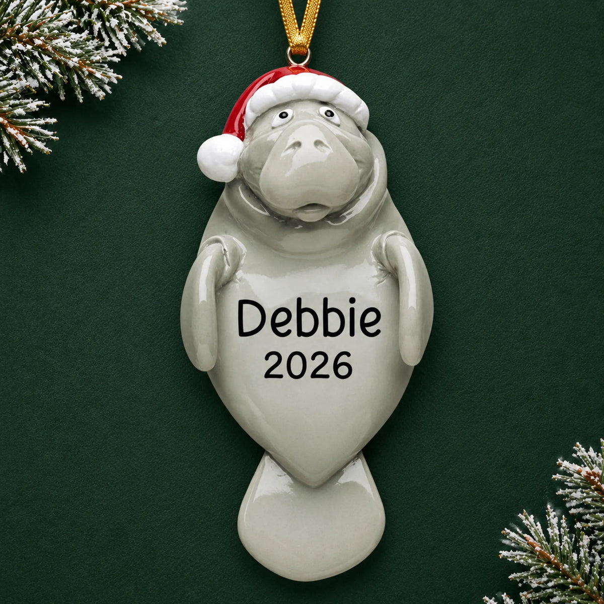 Personalized manatee christmas ornament on a dark green pine background