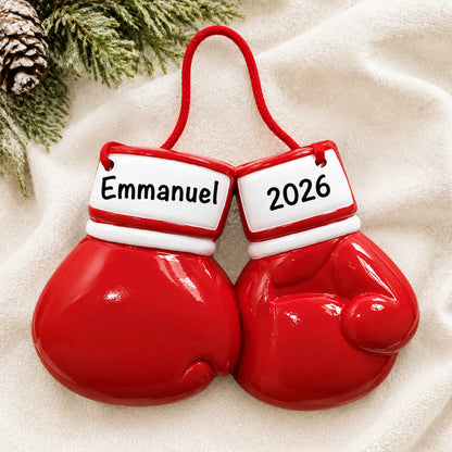 Personalized boxing gloves christmas ornament laid on a soft white knit blanket