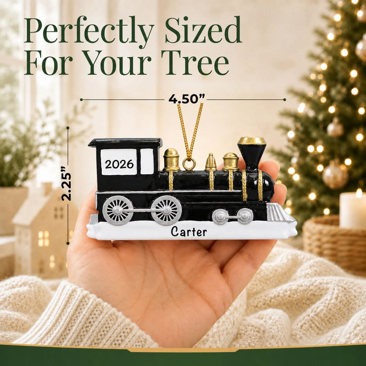 Size guide: the personalized locomotive train christmas ornament is 4.50 in wide by 2.25 in tall, shown in hand
