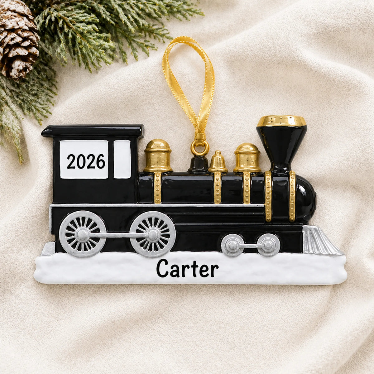 Personalized locomotive train christmas ornament laid on a soft white knit blanket