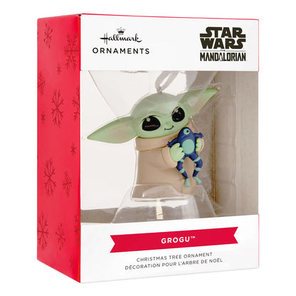 Licensed Star Wars Grogu (Baby Yoda) ornament in beige robe holding blue frog toy with big eyes