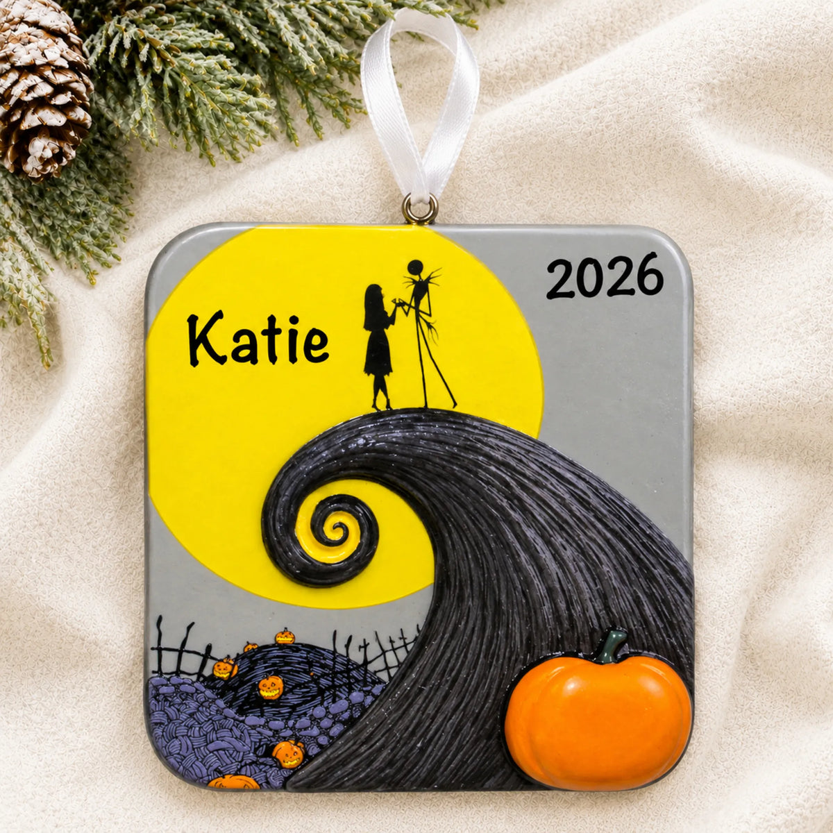Personalized Nightmare Before Christmas ornament laid on a soft white knit blanket