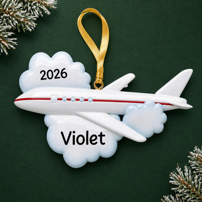 Personalized flying airplane travel christmas ornament on a dark green pine background