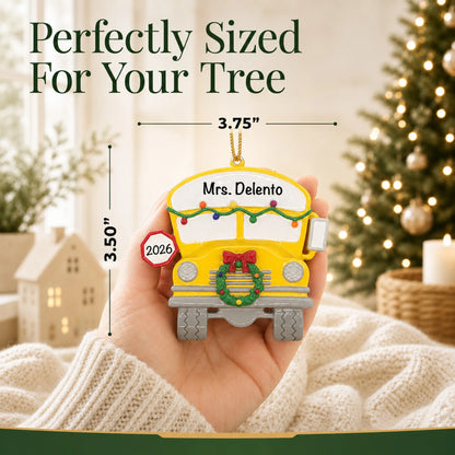 Personalized school bus Christmas ornament held in hand to show its size on the tree