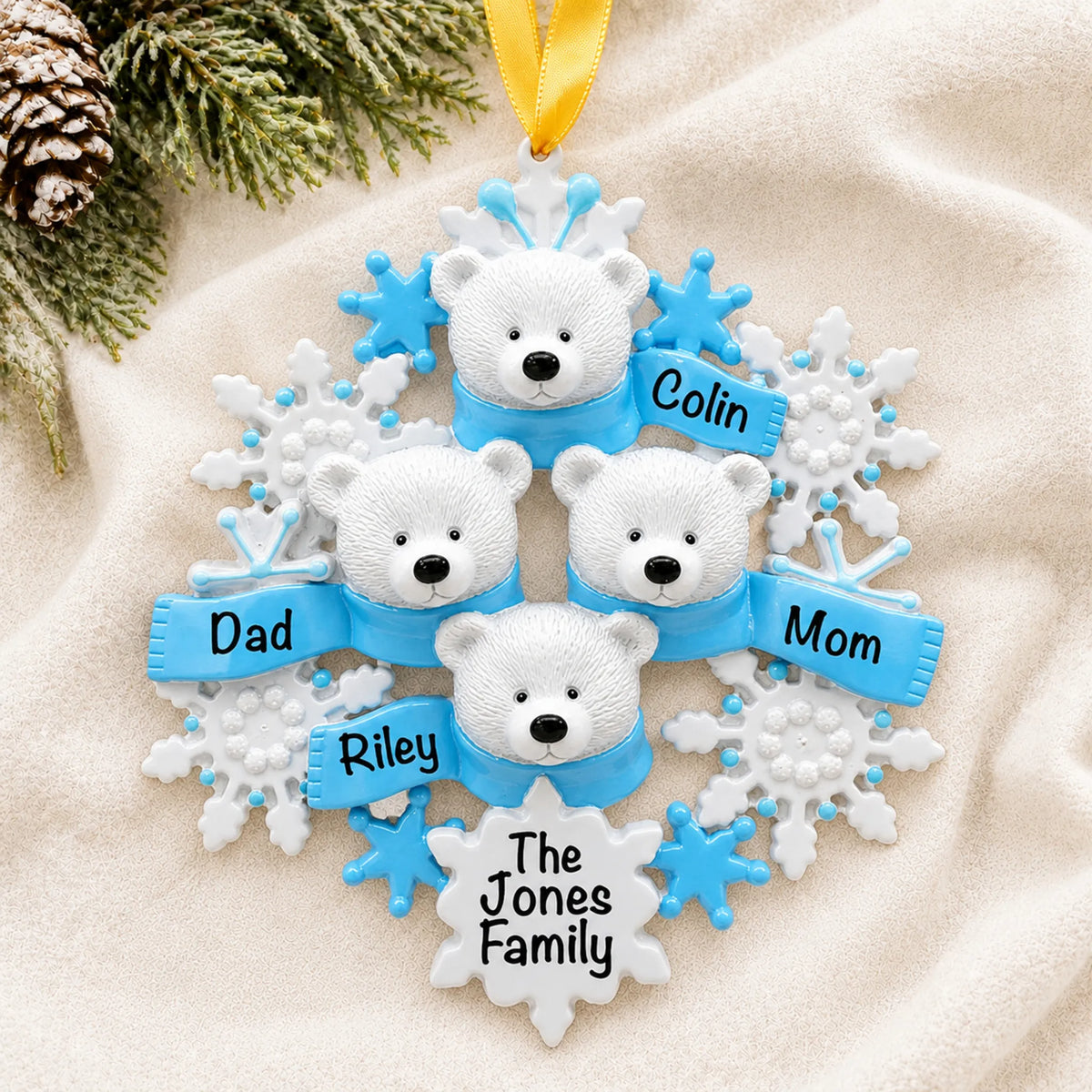 Personalized polar bear family of 4 christmas ornament laid on a soft white knit blanket