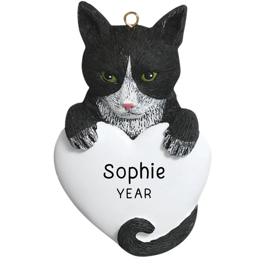 Personalized Christmas ornament featuring a black and white tuxedo cat with green eyes, holding a large blank white heart ready for custom pet name engraving.