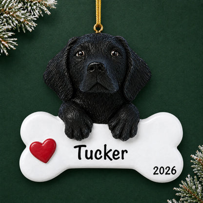 Personalized black Lab dog bone Christmas ornament with a red heart, engraved name and year on a green holiday backdrop
