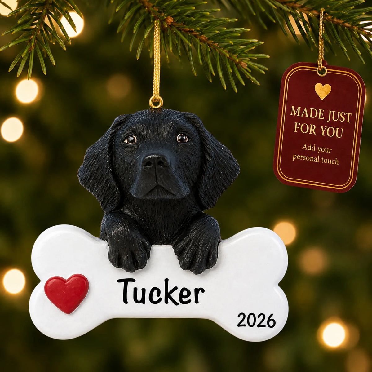 Personalized black Lab Christmas ornament hanging on a lit tree beside a Made Just For You tag