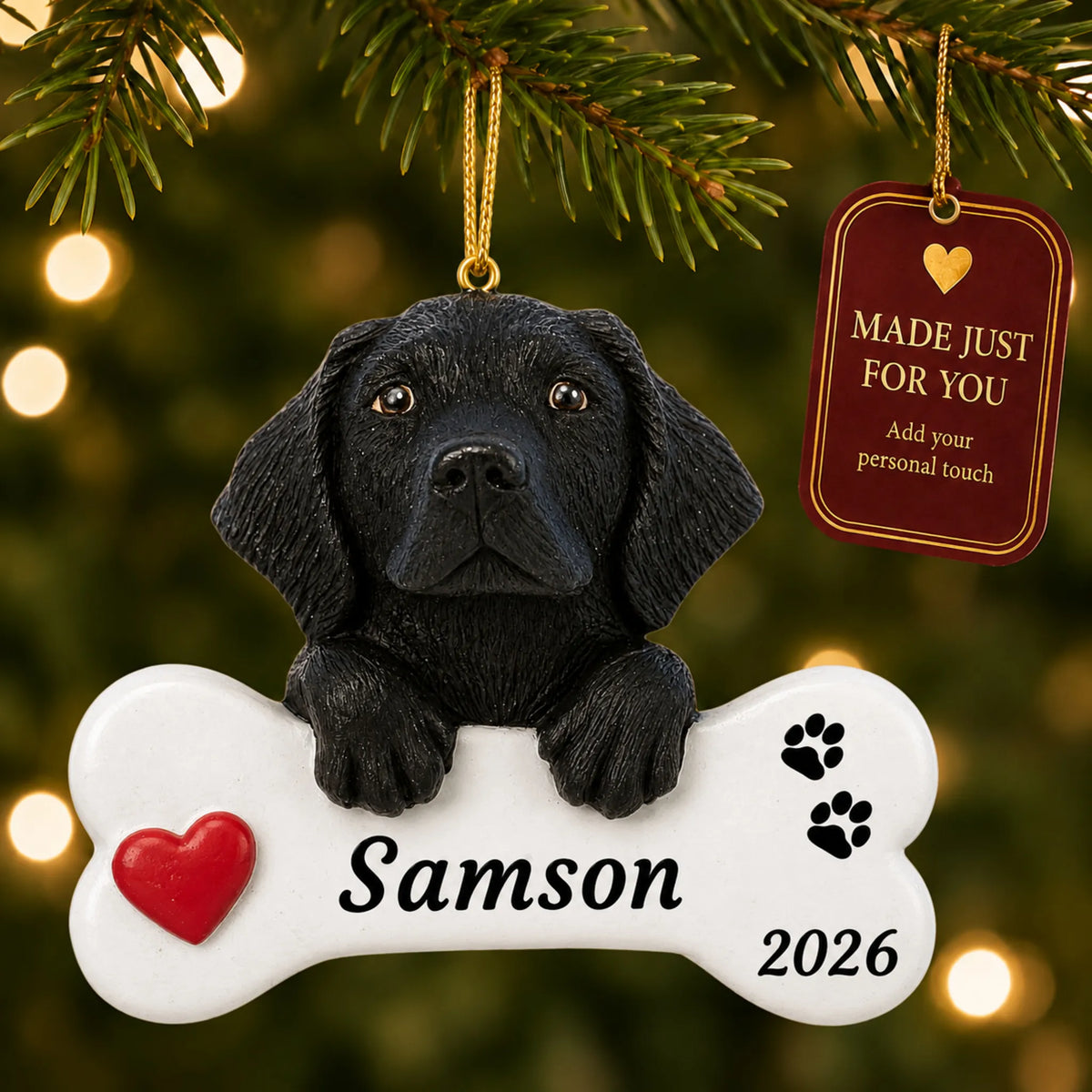 Black Lab Dog Bone christmas ornament hanging on a lit Christmas tree with a Made Just For You gift tag