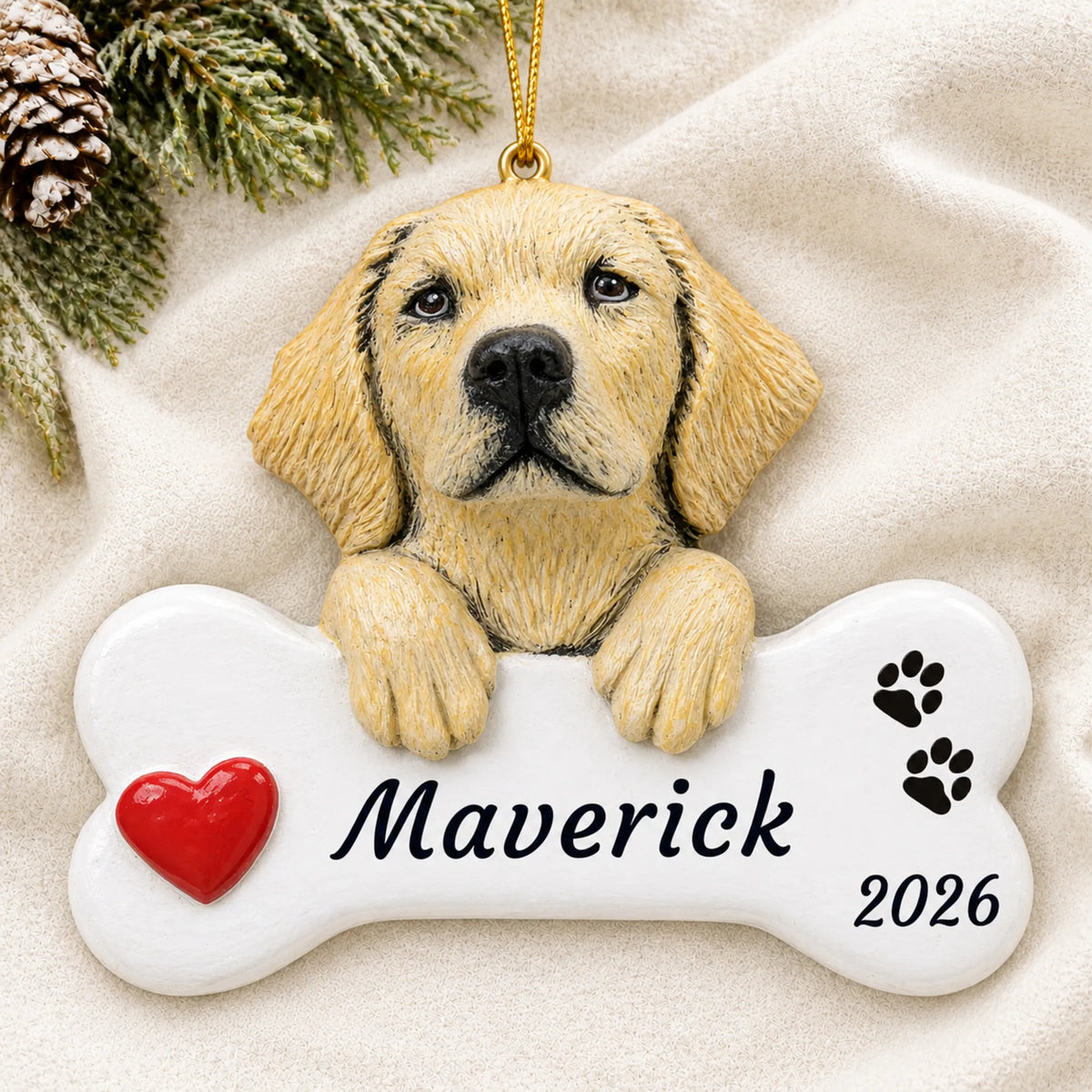 Personalized Yellow Lab Dog Bone christmas ornament laid on a soft white knit blanket