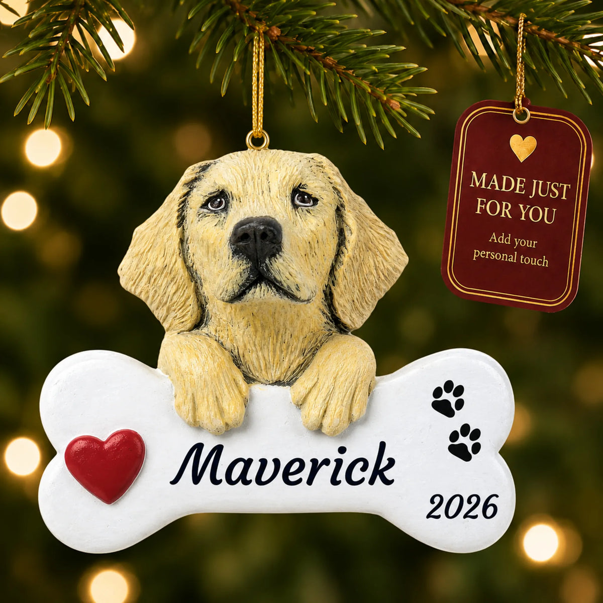 Yellow Lab Dog Bone christmas ornament hanging on a lit Christmas tree with a Made Just For You gift tag