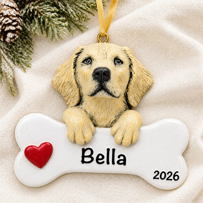 Personalized yellow Lab dog bone Christmas ornament resting on a soft white blanket with pine and pinecones