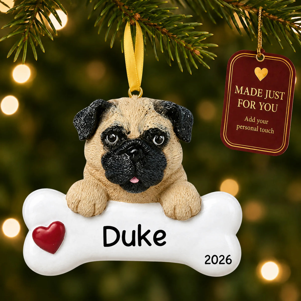 Personalized pug Christmas ornament hanging on a lit tree beside a Made Just For You tag