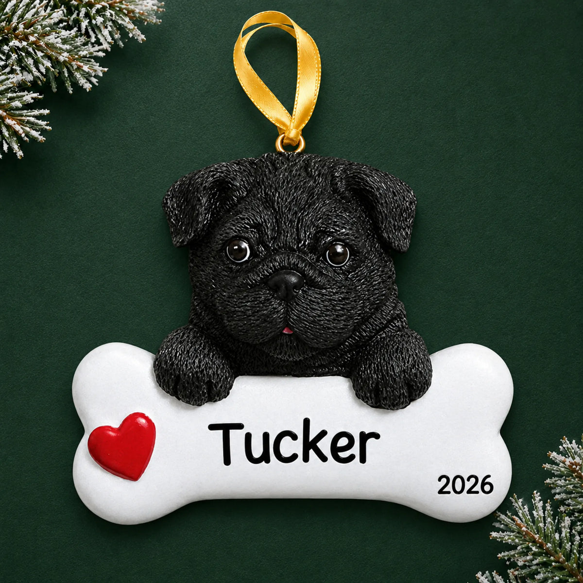 Personalized black pug dog bone Christmas ornament, engraved with a name and year, on a green holiday backdrop