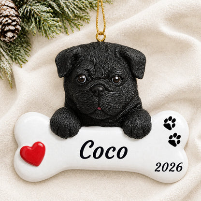 Personalized Black Pug Dog Bone christmas ornament laid on a soft white knit blanket