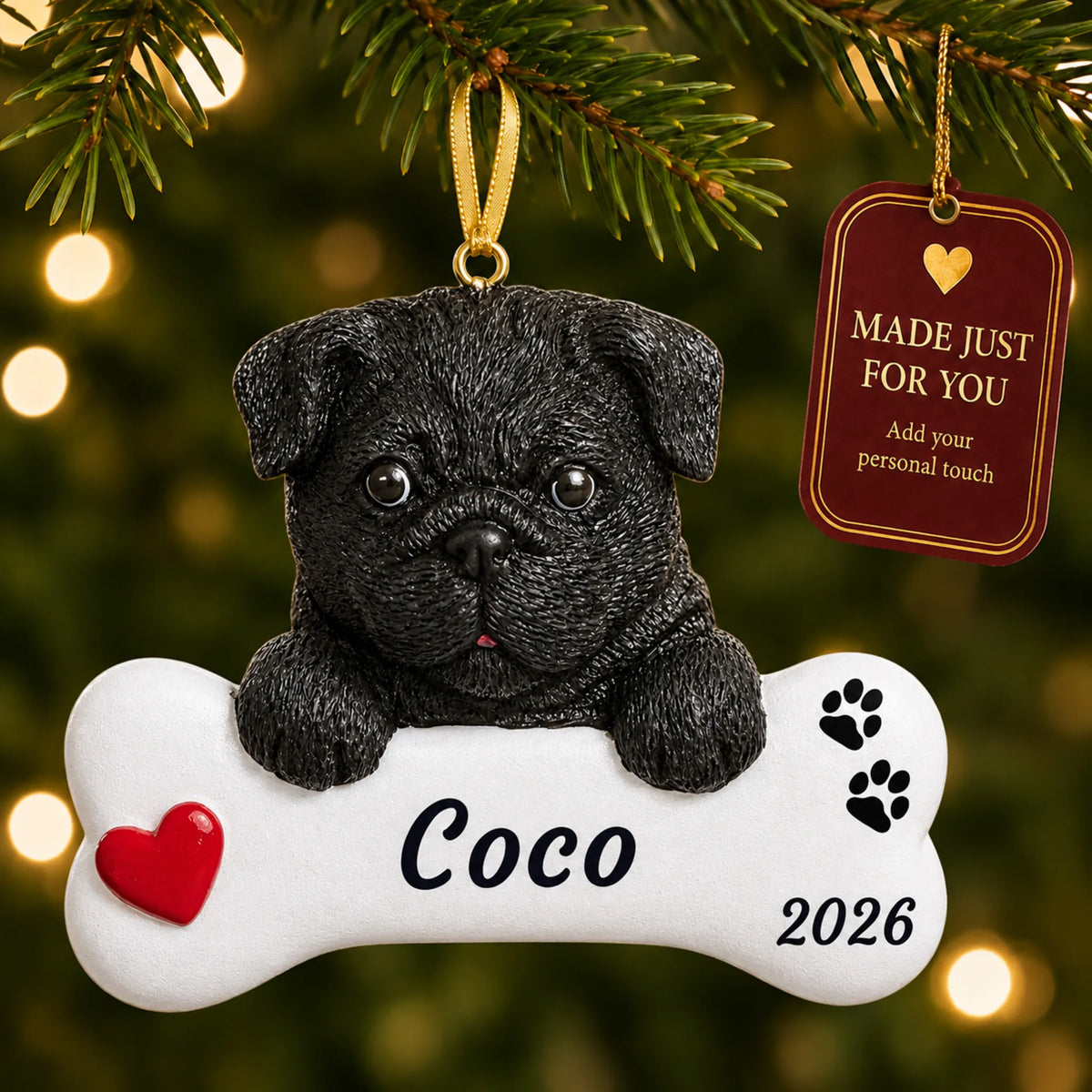 Black Pug Dog Bone christmas ornament hanging on a lit Christmas tree with a Made Just For You gift tag