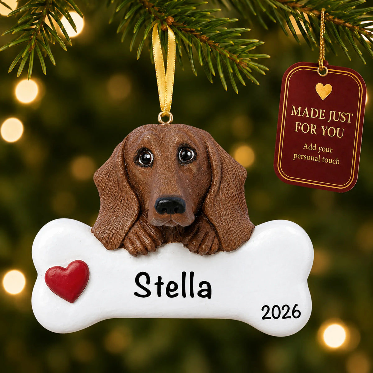 Personalized dachshund Christmas ornament hanging on a lit tree beside a Made Just For You tag