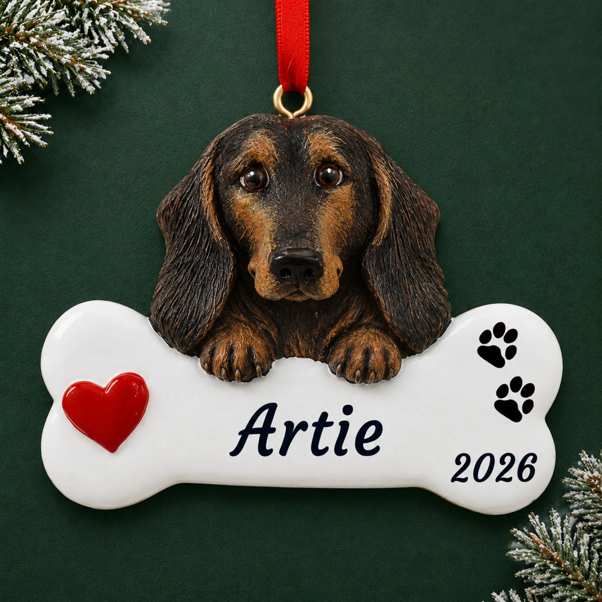 Personalized Black & Tan Dachshund Dog Bone christmas ornament on a dark green pine background