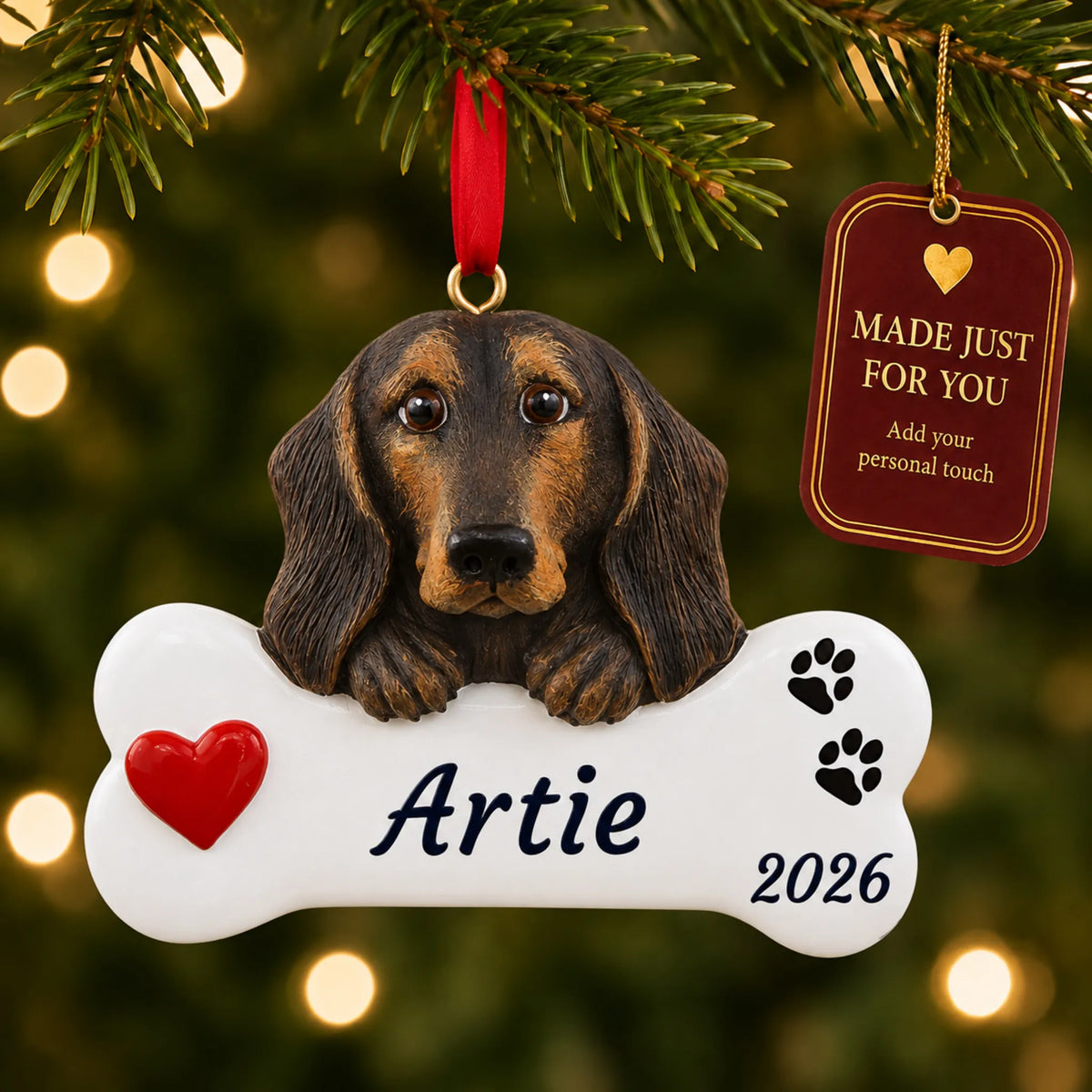 Black & Tan Dachshund Dog Bone christmas ornament hanging on a lit Christmas tree with a Made Just For You gift tag