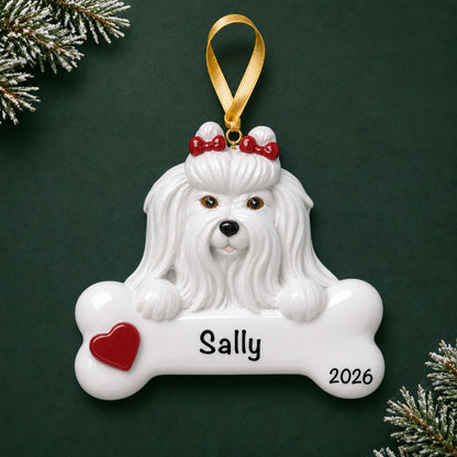 Personalized Maltese dog bone Christmas ornament, engraved with a name and year, on a green holiday backdrop