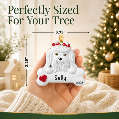 Hand holding the personalized Maltese Christmas ornament to show its 3.75 inch width