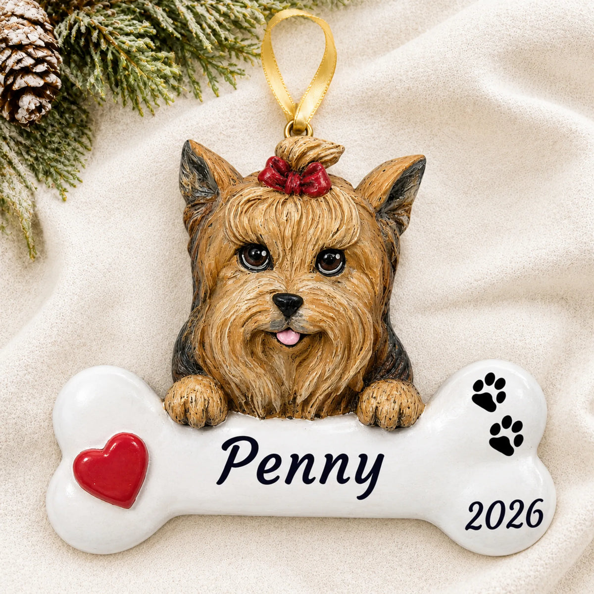 Personalized Yorkie Dog Bone christmas ornament laid on a soft white knit blanket