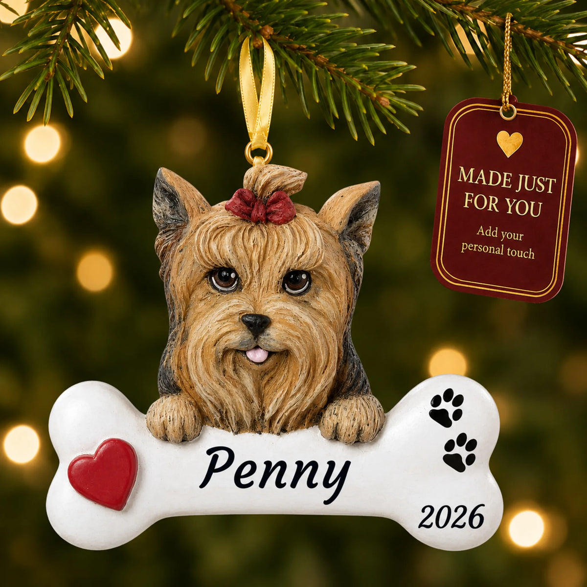 Yorkie Dog Bone christmas ornament hanging on a lit Christmas tree with a Made Just For You gift tag