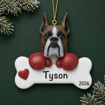 Personalized boxer dog bone Christmas ornament, engraved with a name and year, on a green holiday backdrop