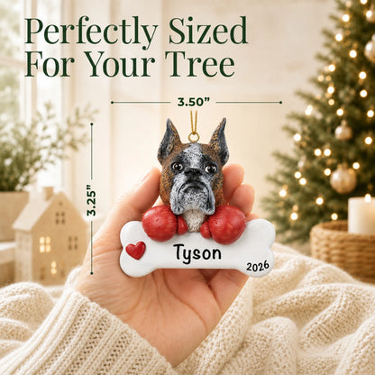 Hand holding the personalized boxer Christmas ornament to show its 3.50 inch width