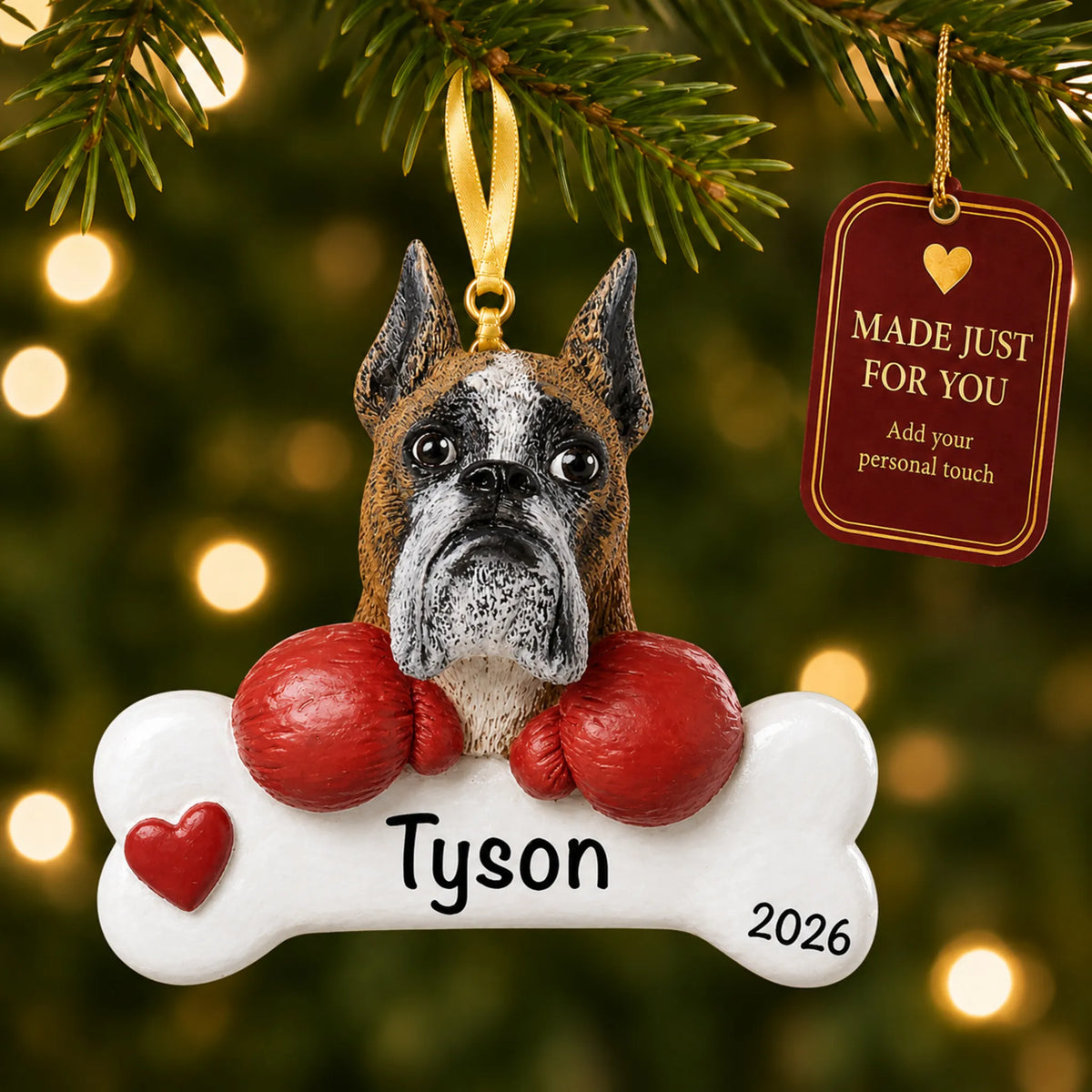 Personalized boxer Christmas ornament hanging on a lit tree beside a Made Just For You tag