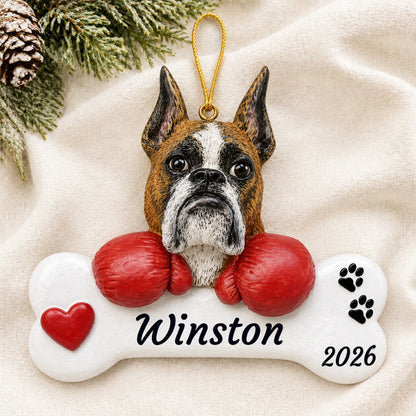 Personalized Boxer Dog Bone christmas ornament laid on a soft white knit blanket