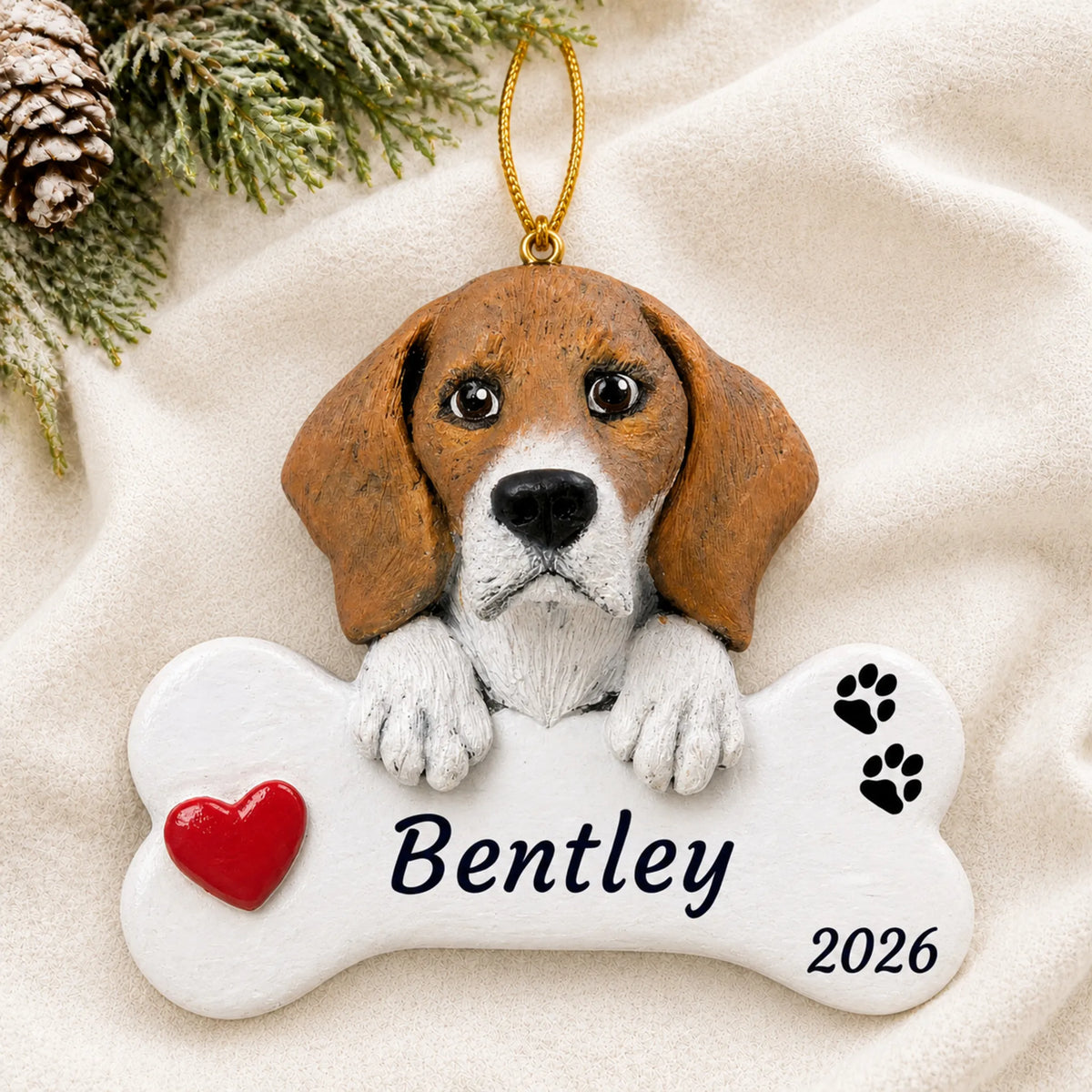 Personalized Beagle Dog Bone christmas ornament laid on a soft white knit blanket