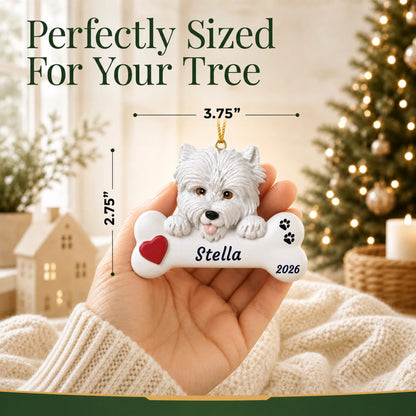Size guide: the personalized Westie Dog Bone christmas ornament is 3.75 in wide by 2.75 in tall, shown in hand