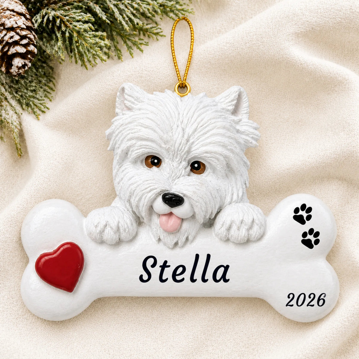 Personalized Westie Dog Bone christmas ornament laid on a soft white knit blanket
