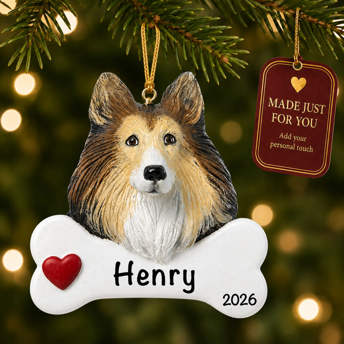 Personalized collie Christmas ornament hanging on a lit tree beside a Made Just For You tag
