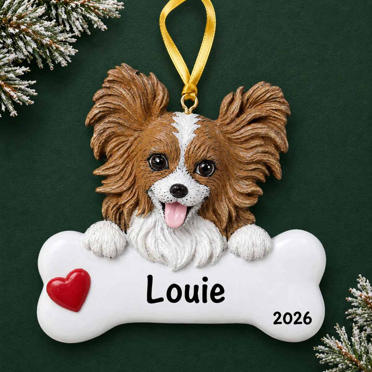Personalized papillon dog bone Christmas ornament, engraved with a name and year, on a green holiday backdrop