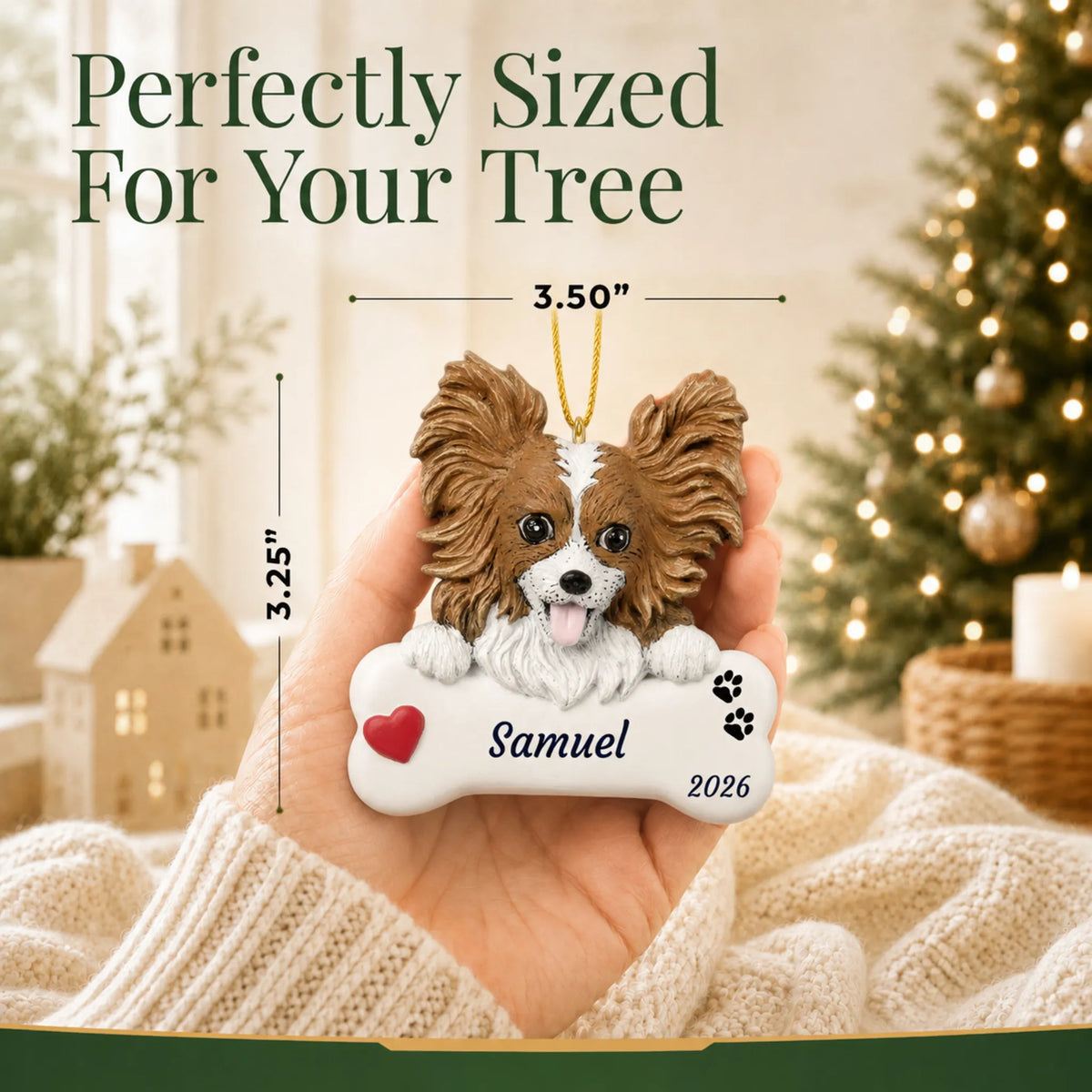 Size guide: the personalized Papillon Dog Bone christmas ornament is 3.50 in wide by 3.25 in tall, shown in hand